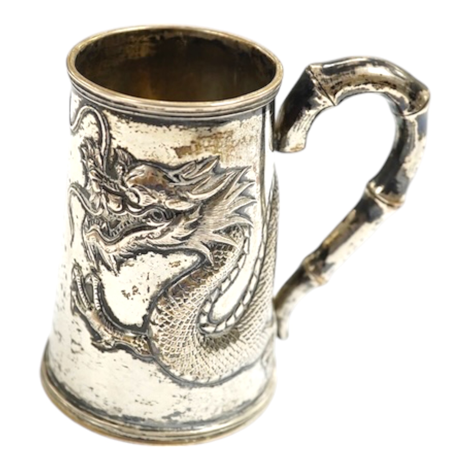 A small Chinese Export white metal mug, embossed with a dragon, 68mm, 66 grams. Condition - fair